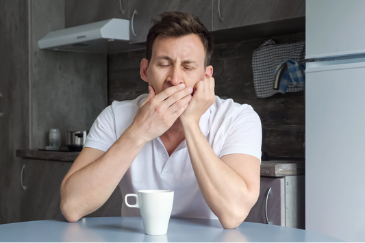 man yawning Understanding and Overcoming Morning Grogginess with SleepCreme